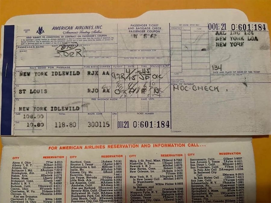 An old American Airlines paper ticket from New York Idlewild to St. Louis, showing handwritten notes, ticket details, and contact information on the bottom section.