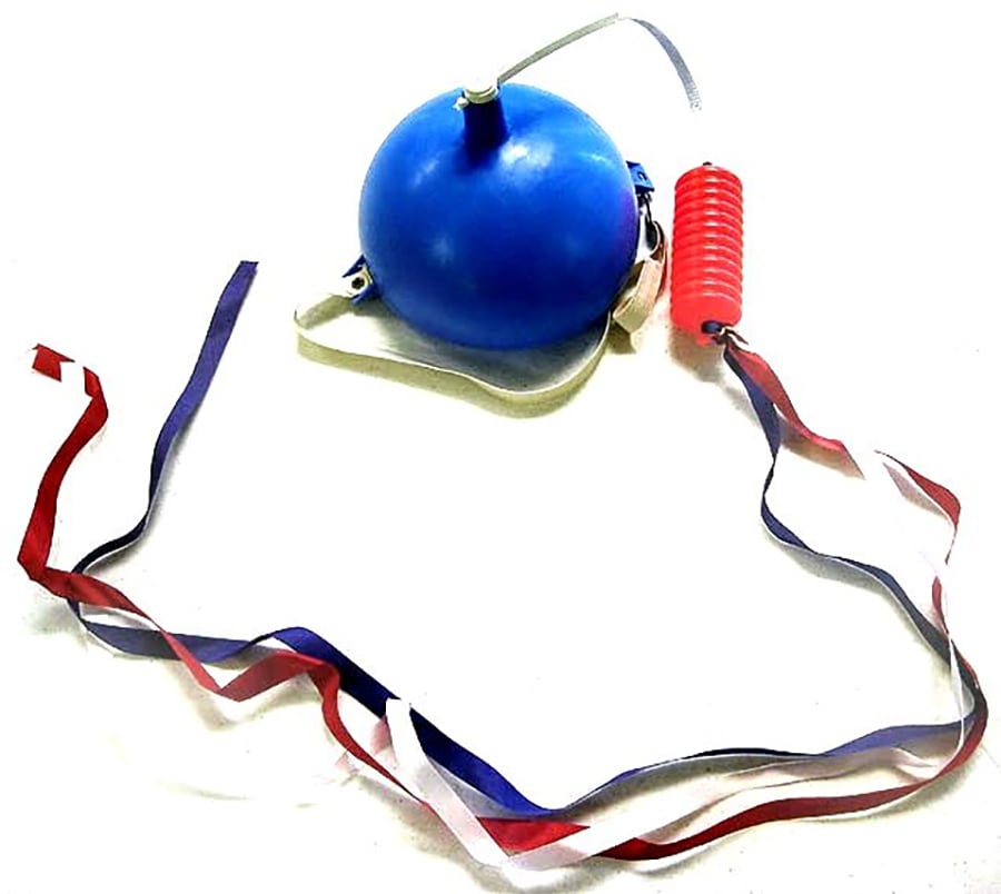 A blue balloon attached to a red plastic handle with long red, white, and blue ribbons trailing from it, used as a punch balloon toy.