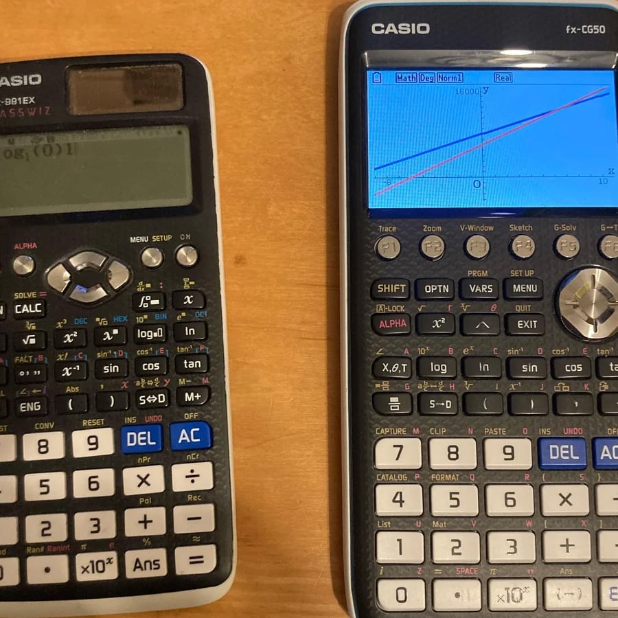 Two Casio scientific calculators on a wooden surface. The left calculator has a basic display, while the right one has a color screen showing a graph with lines and math functions. Both devices have multiple buttons.