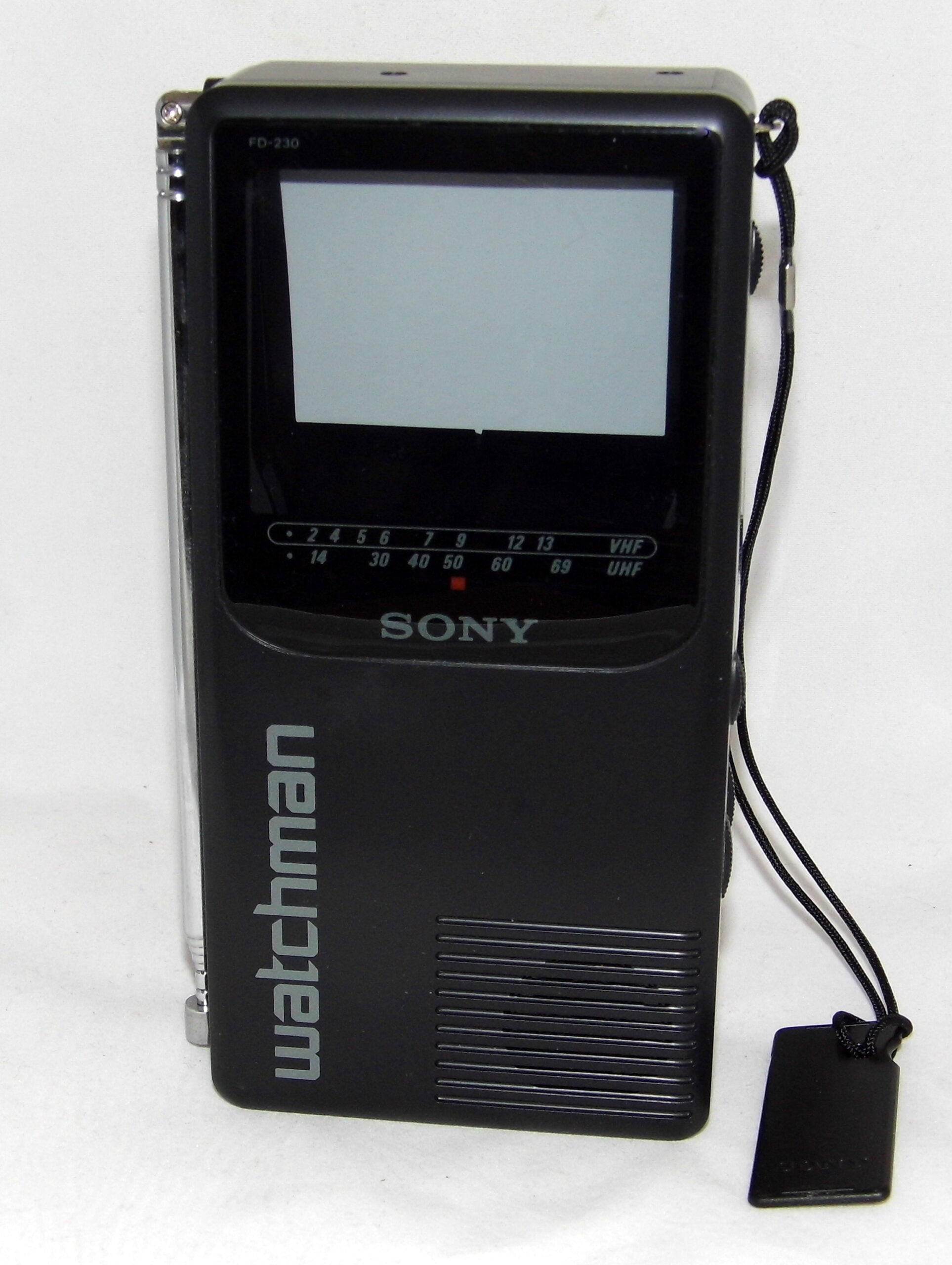 A black Sony Watchman portable TV with a small screen, labeled FD-250, buttons, speaker grille, and a wrist strap, shown upright on a white background.