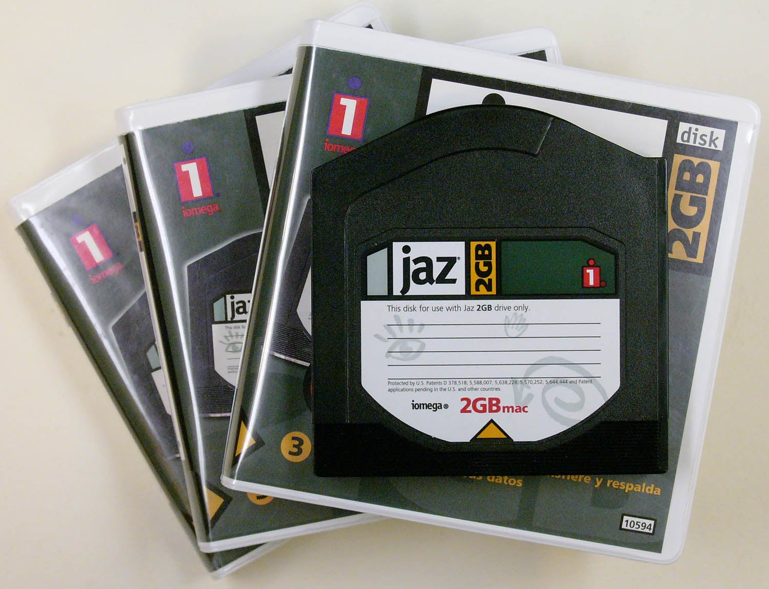A stack of three Iomega Jaz disk cases with a 2GB Jaz disk on top, labeled for use with a 2GB drive.