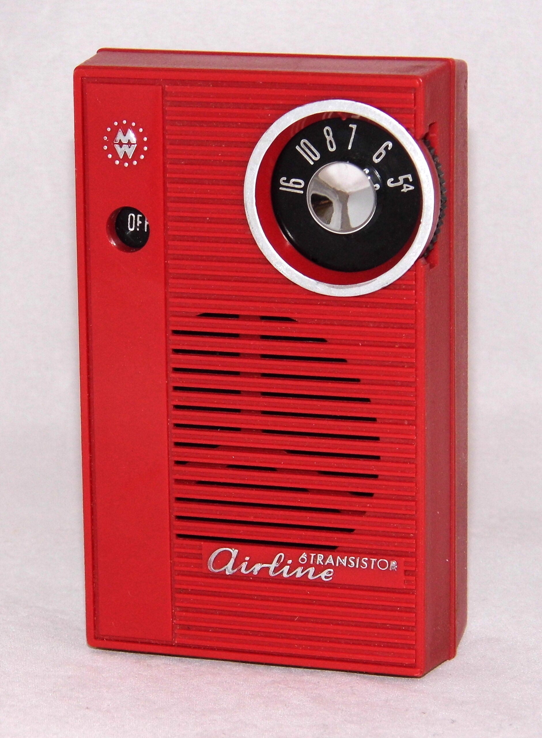 A vintage red transistor radio with a circular tuning dial, an off switch, and the word “Airline” written on the front. The radio has horizontal speaker vents and a simple, rectangular design.