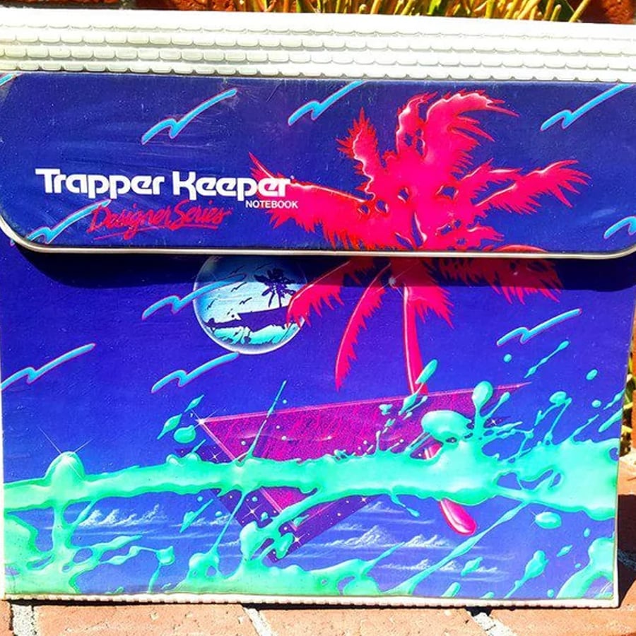 A vibrant Trapper Keeper folder with neon palm trees, a moon, and splashes of bright green and pink on a blue background, evoking an 80s retro tropical theme.