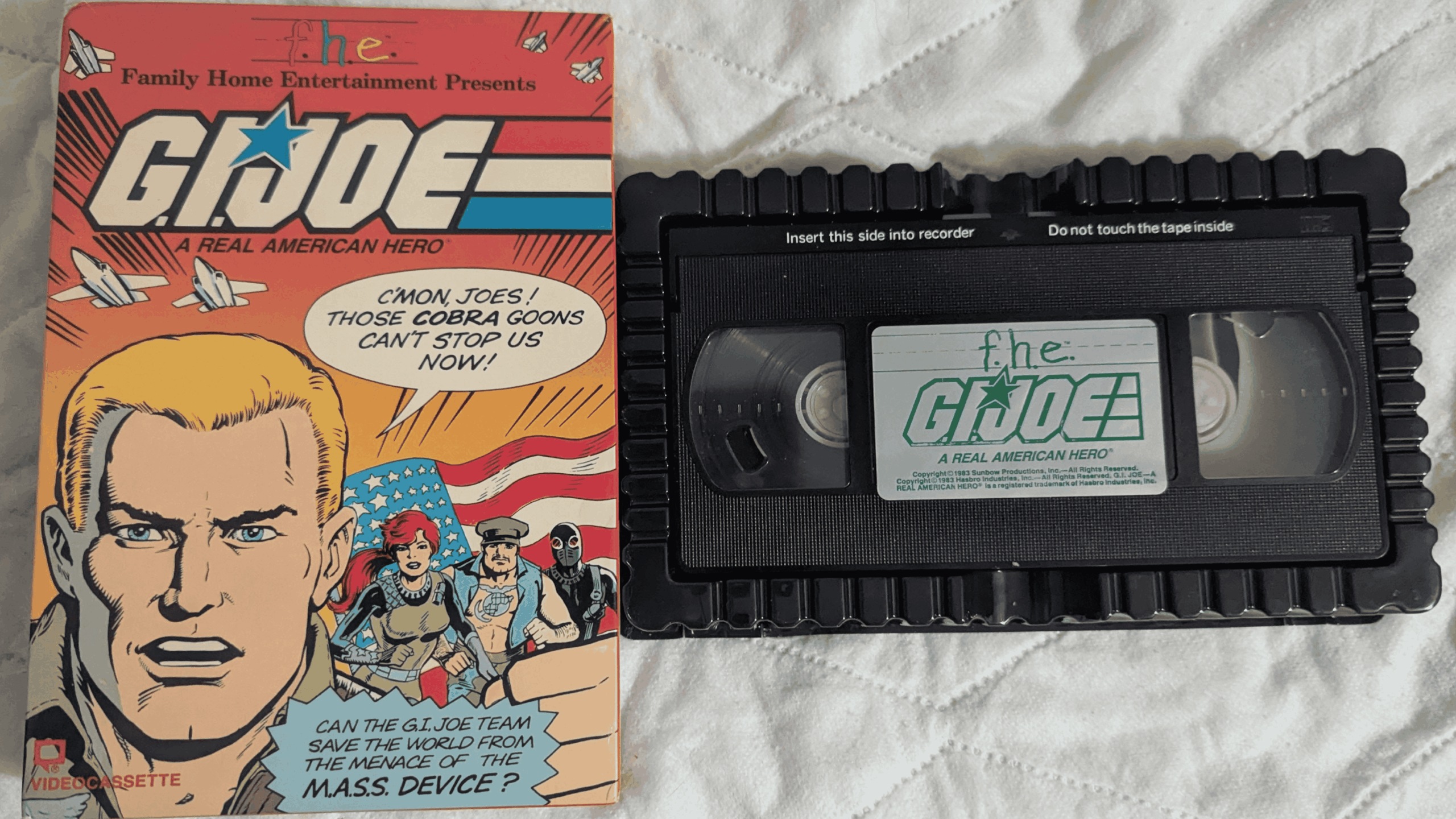 A G.I. Joe VHS tape sits next to its colorful case, which features comic-style art of characters and text promoting “A Real American Hero.”