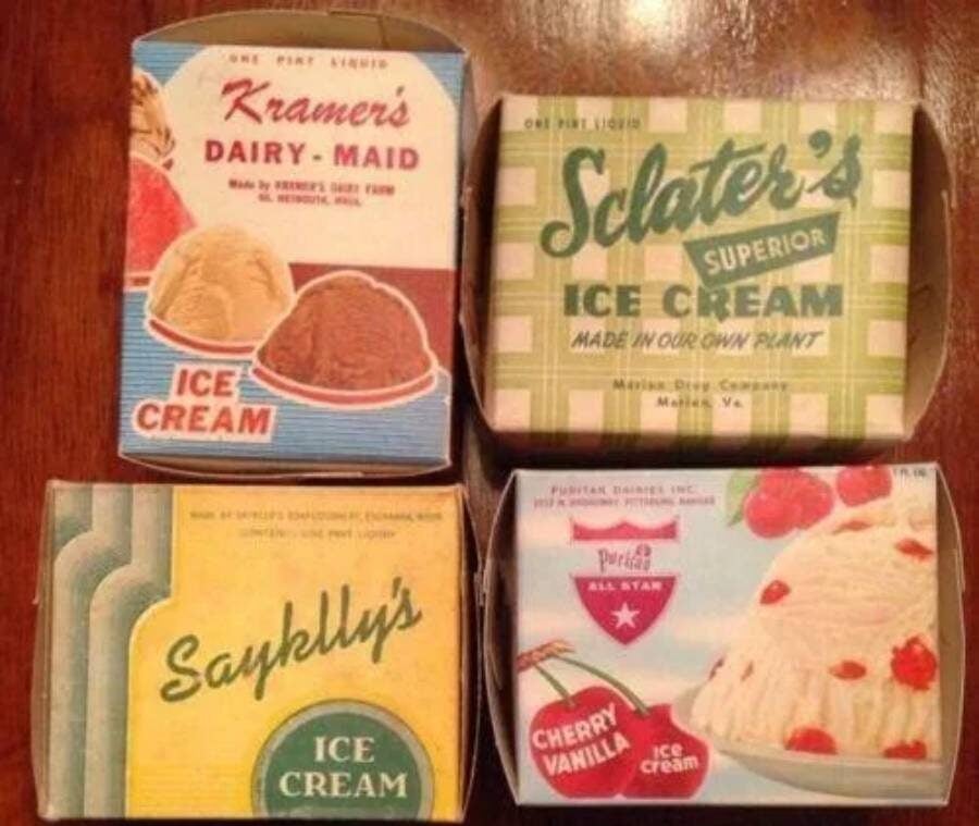 Four vintage ice cream cartons on a wooden surface, each with colorful retro designs and brand names: Kramer’s Dairy-Maid, Sclater’s, Saybelly’s, and Purity All Star Cherry Vanilla.