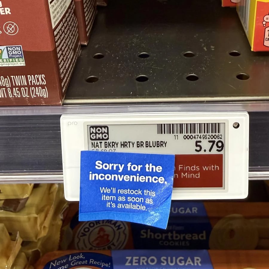 A store shelf with an empty spot for Nature’s Bakery Blueberry bars, labeled $5.79, and a blue sign saying, “Sorry for the inconvenience. We’ll restock this item as soon as it’s available.”