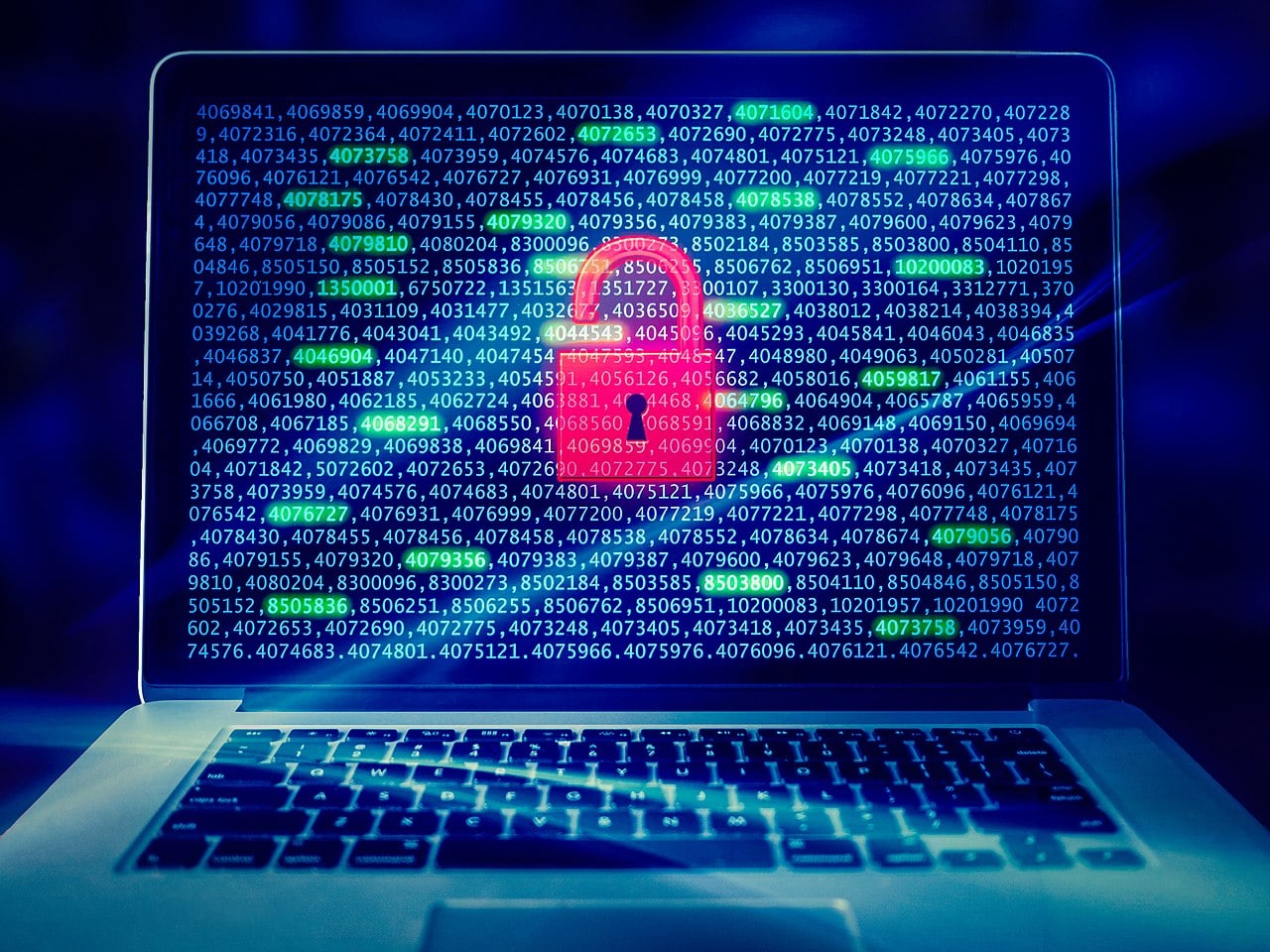 A laptop displays a red padlock icon over lines of blue code, suggesting a cybersecurity threat or data breach.
