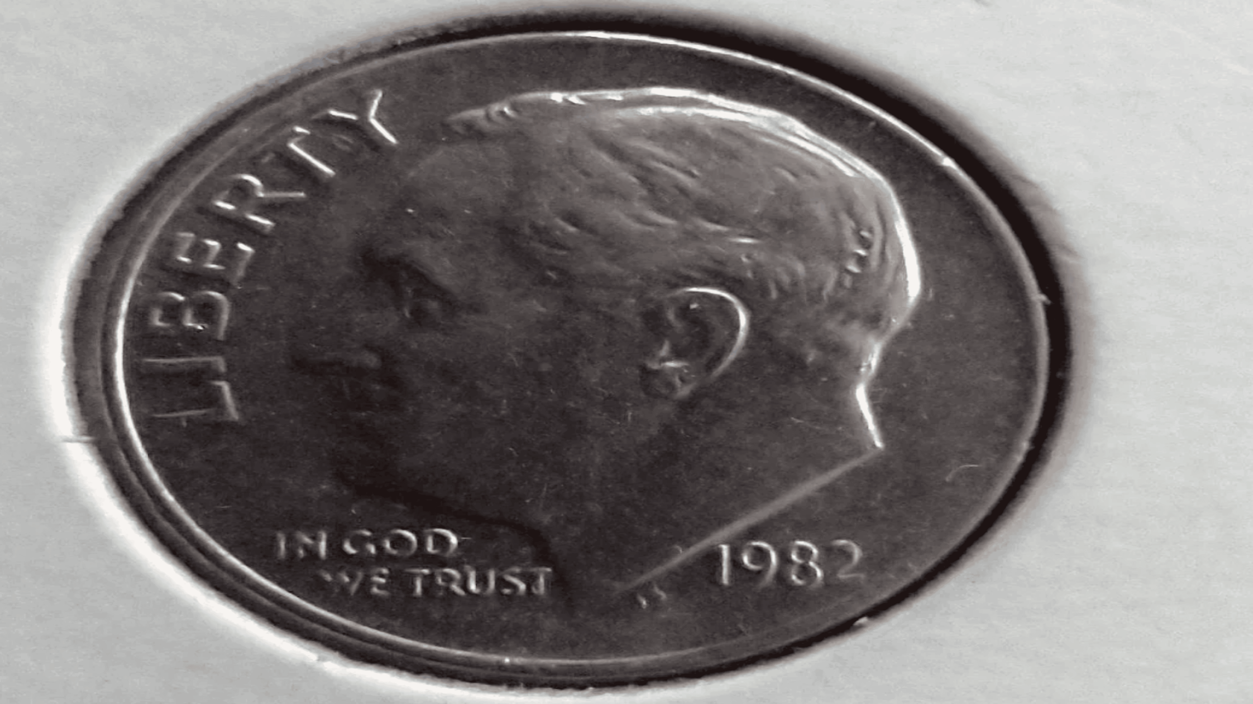 A close-up of a 1982 US dime featuring the profile of President Franklin D. Roosevelt, with the words “LIBERTY” and “IN GOD WE TRUST” visible.
