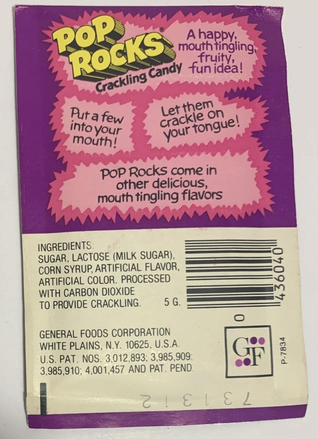 A colorful Pop Rocks candy wrapper with pink and purple design, promoting its crackling effect. The ingredients and manufacturer details are shown, along with fun phrases about the candy’s crackling sensation.