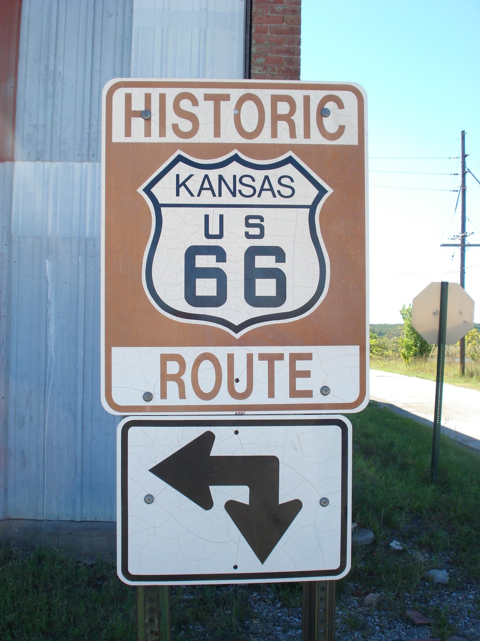 A sign for historic Kansas U.S. Route 66 with an arrow below pointing both left and right, indicating directions for the route.