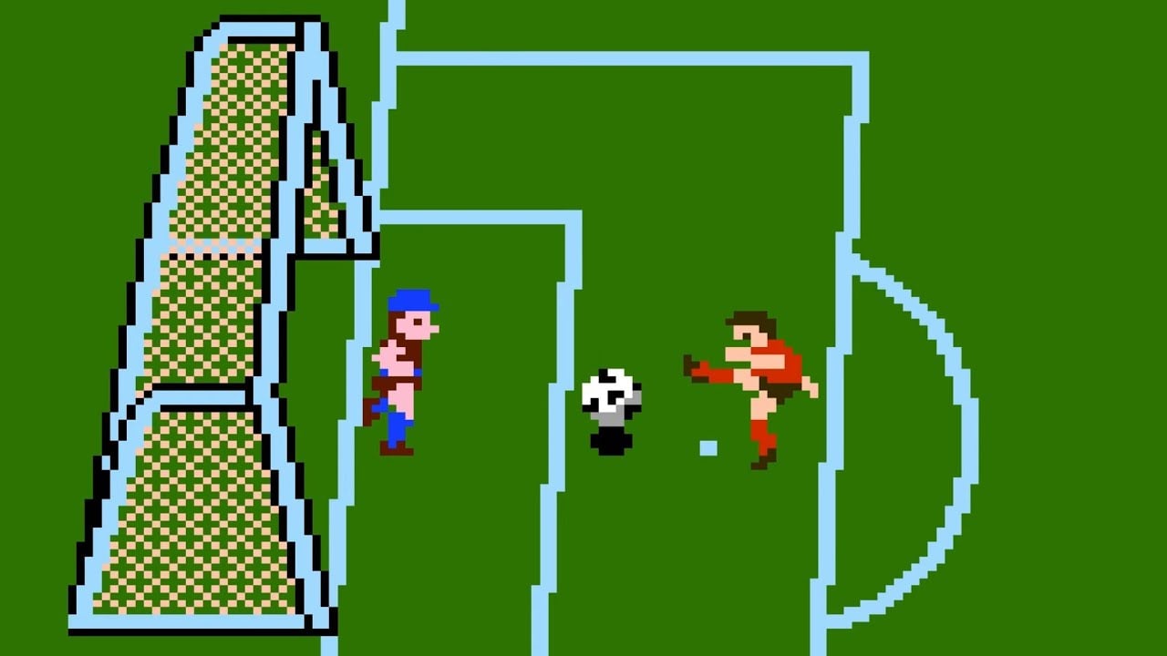 Two pixelated soccer players face each other near a goal on a green field in a retro video game. One player is kicking a black-and-white soccer ball toward the goal while the other stands nearby.