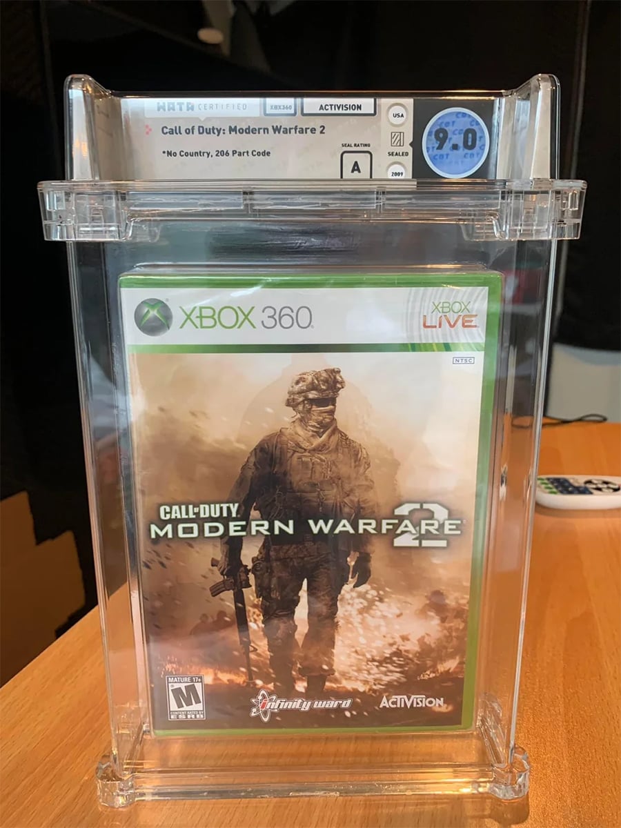Sealed, graded Xbox 360 Call of Duty: Modern Warfare 2 game in a display case, with a 9.0 WATA rating label shown at the top.
