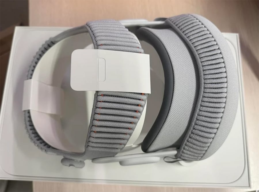 Two gray adjustable watch bands with textured patterns are neatly placed side by side in a white box on a light-colored surface.