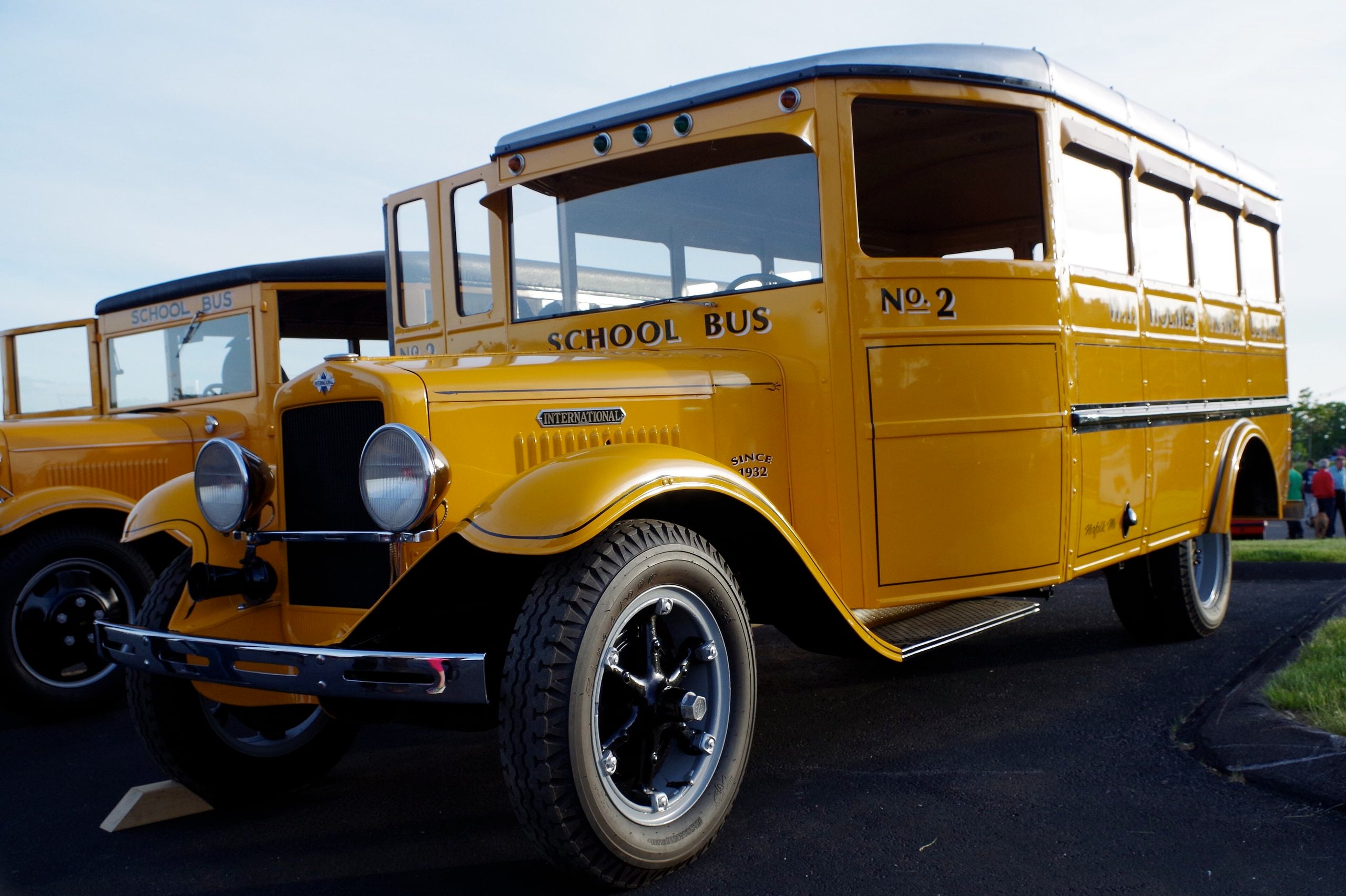 A vintage yellow International school bus labeled “No. 2” parked on asphalt.