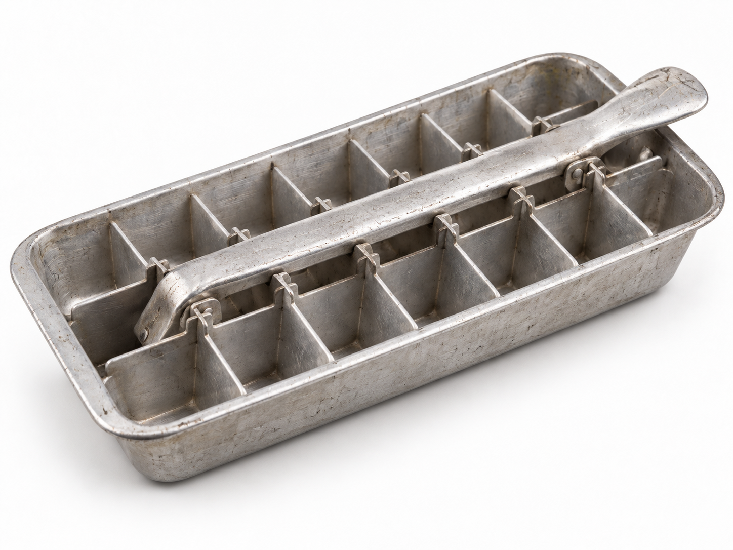 Vintage metal ice cube tray with a lever handle for releasing ice.