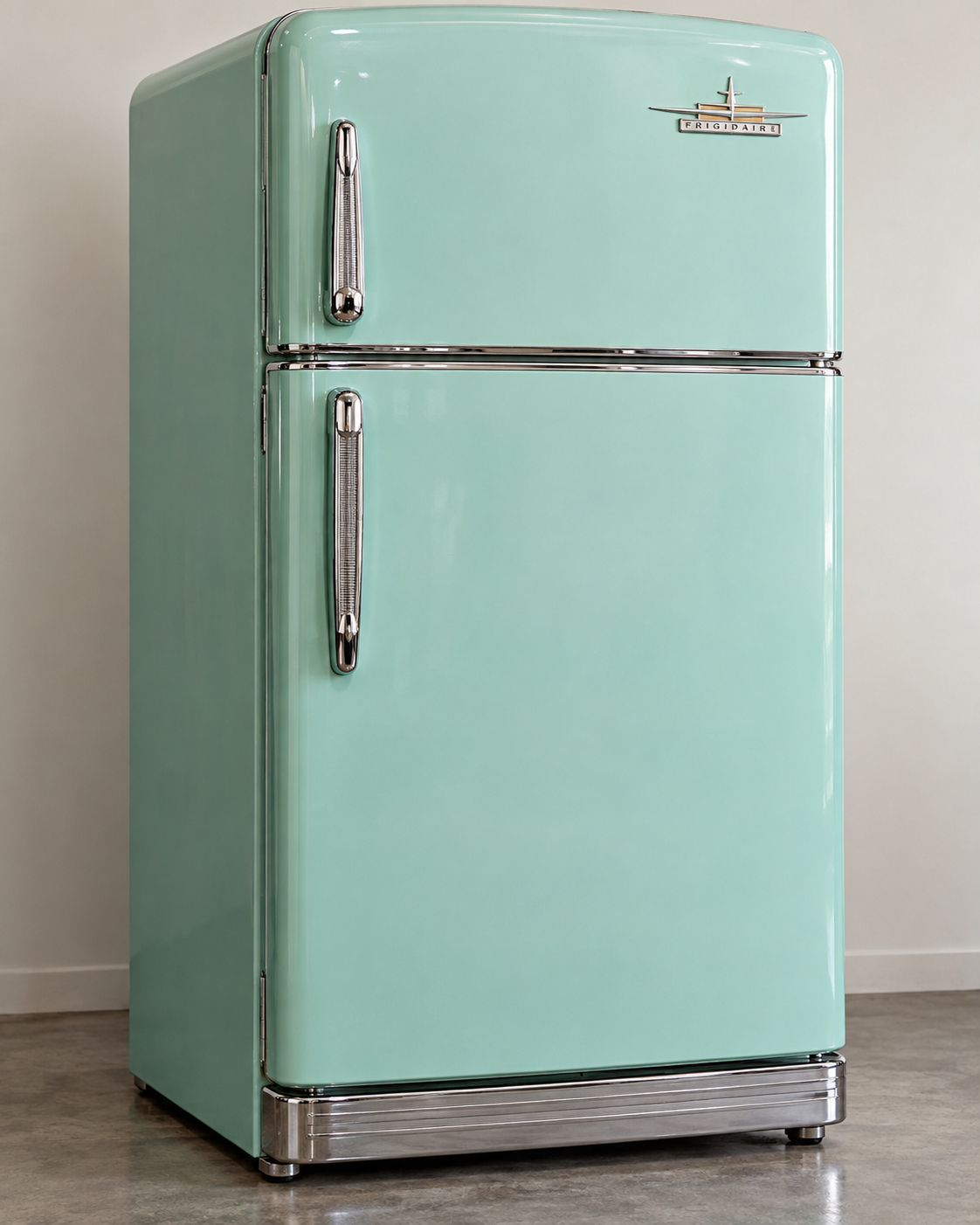 A vintage-style, mint green Frigidaire refrigerator with chrome handles and trim.