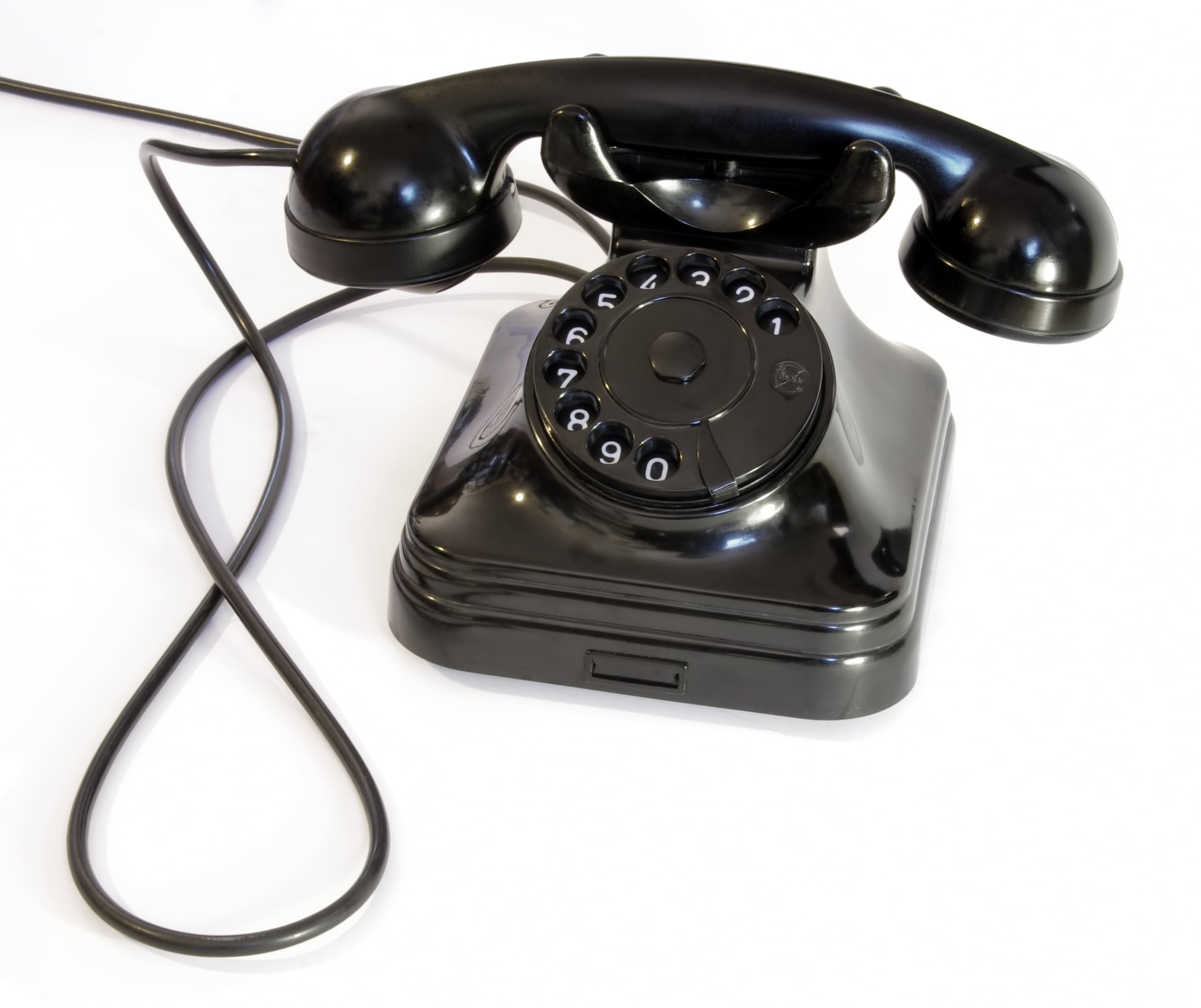 Vintage black rotary telephone with a handset resting on the base.