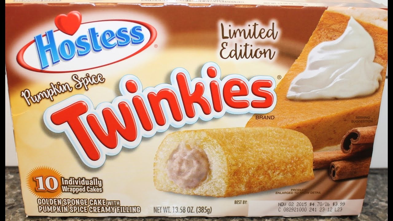 Box of limited edition Pumpkin Spice Twinkies showing a golden sponge cake with cream filling, a slice of pumpkin cake, and cinnamon sticks.