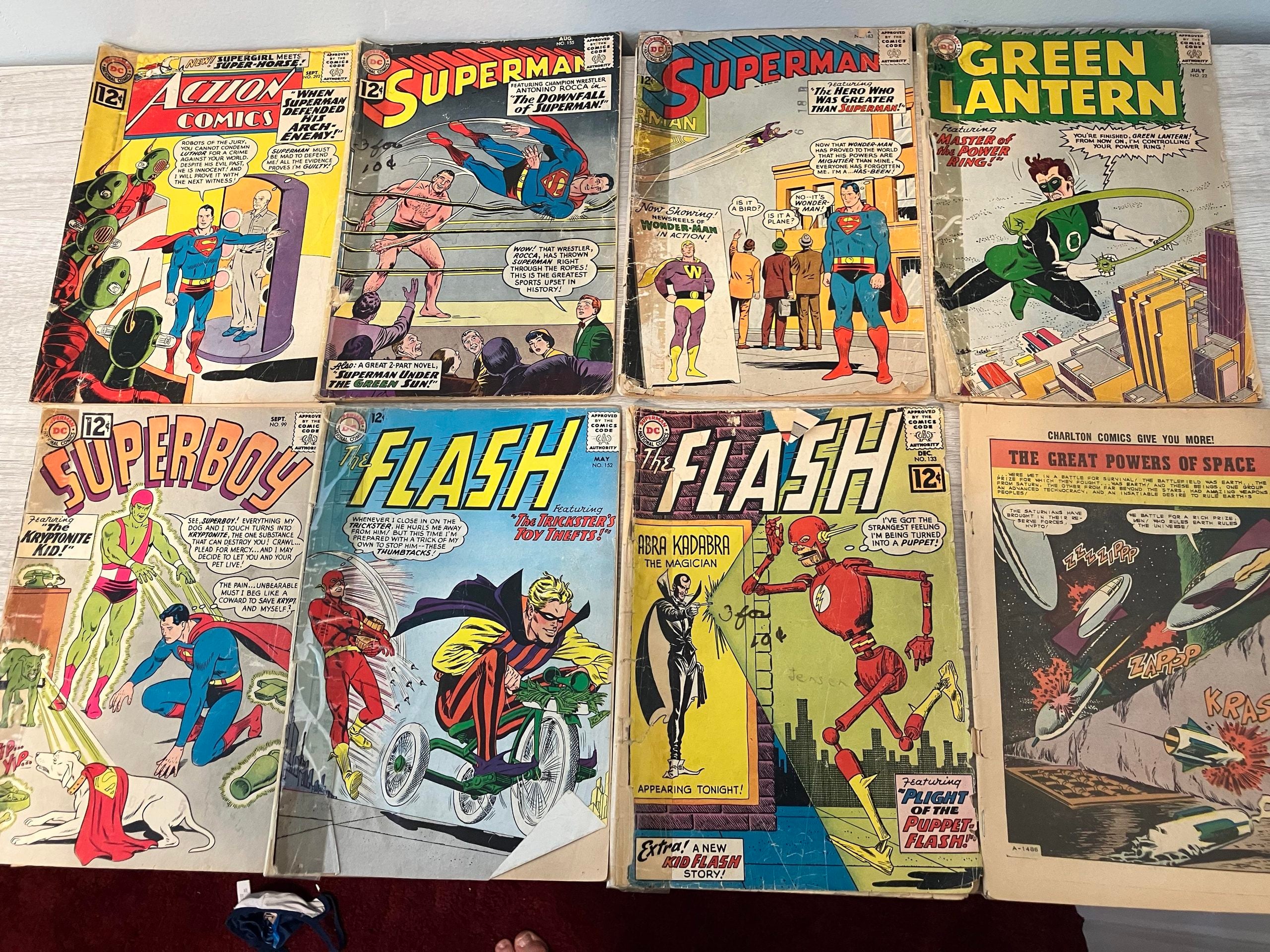 Eight vintage comic books from the Silver Age arranged in two rows, including issues of Superman, Action Comics, Green Lantern, Superboy, and The Flash.
