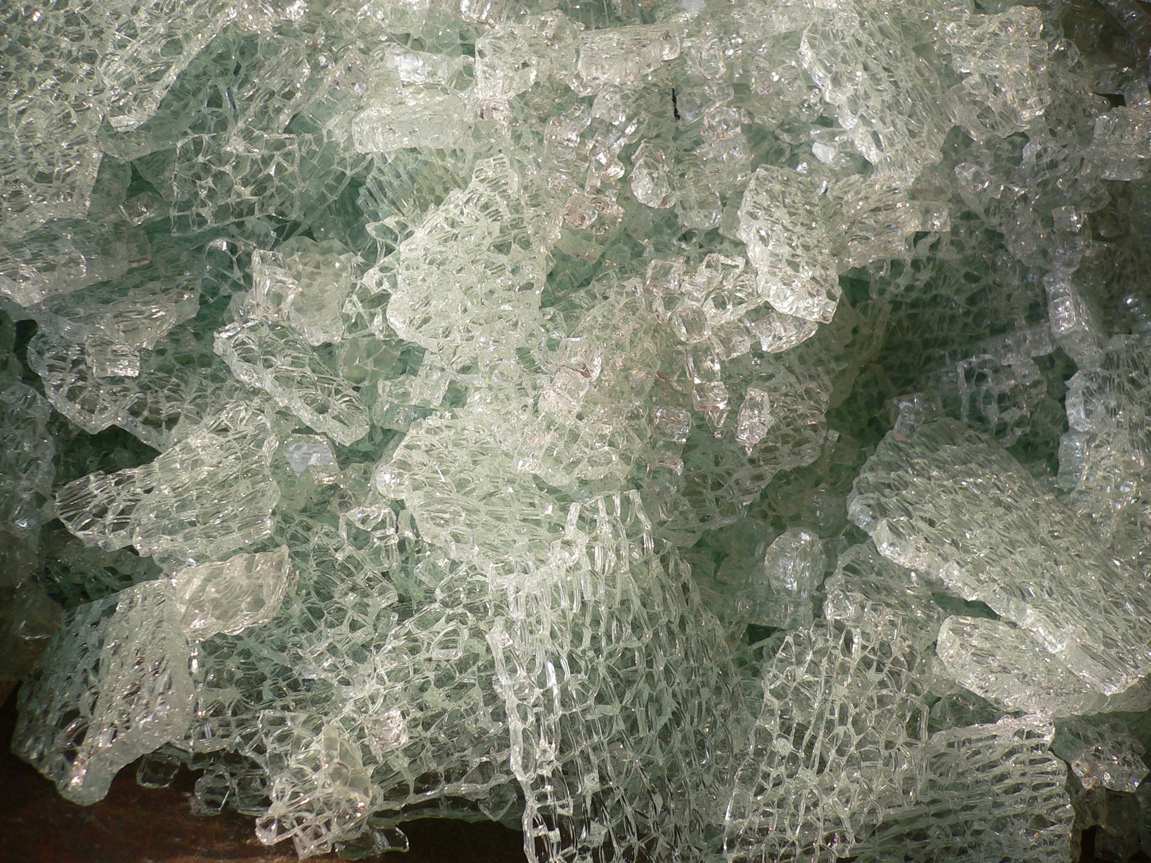 A pile of shattered tempered glass fragments.