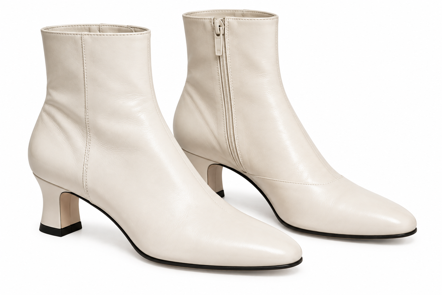 Off-white leather ankle boots with a side zipper and a low block heel.