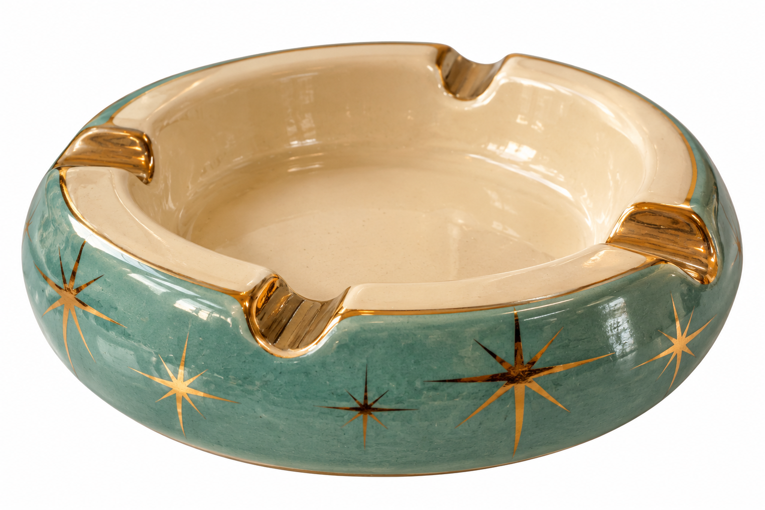Round teal ceramic ashtray with a cream-colored interior and gold starburst patterns on the exterior.