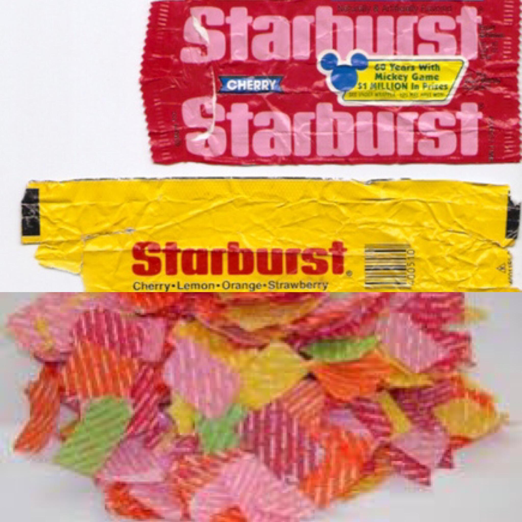 A red Starburst candy wrapper, a yellow Starburst wrapper, and a pile of small, colorful shredded candy wrapper pieces.