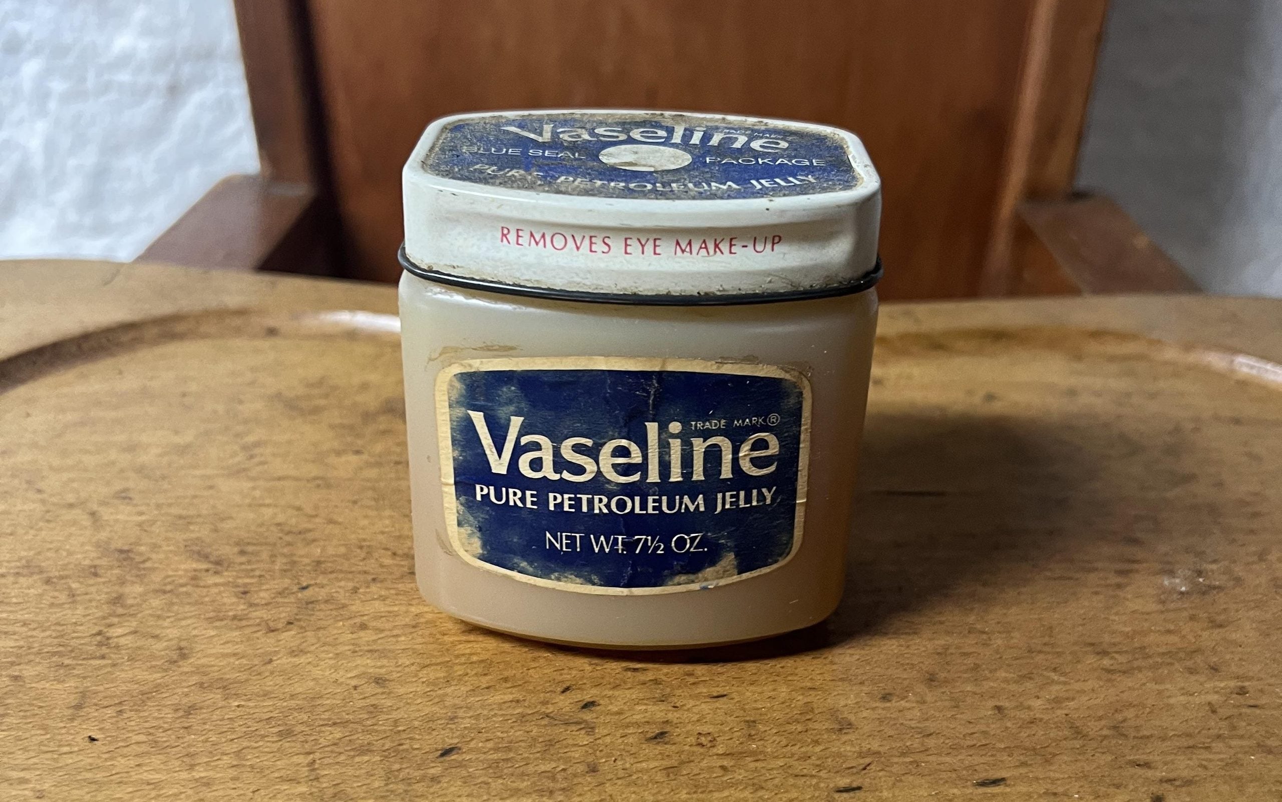 Vintage jar of Vaseline Pure Petroleum Jelly with a blue label and white lid.