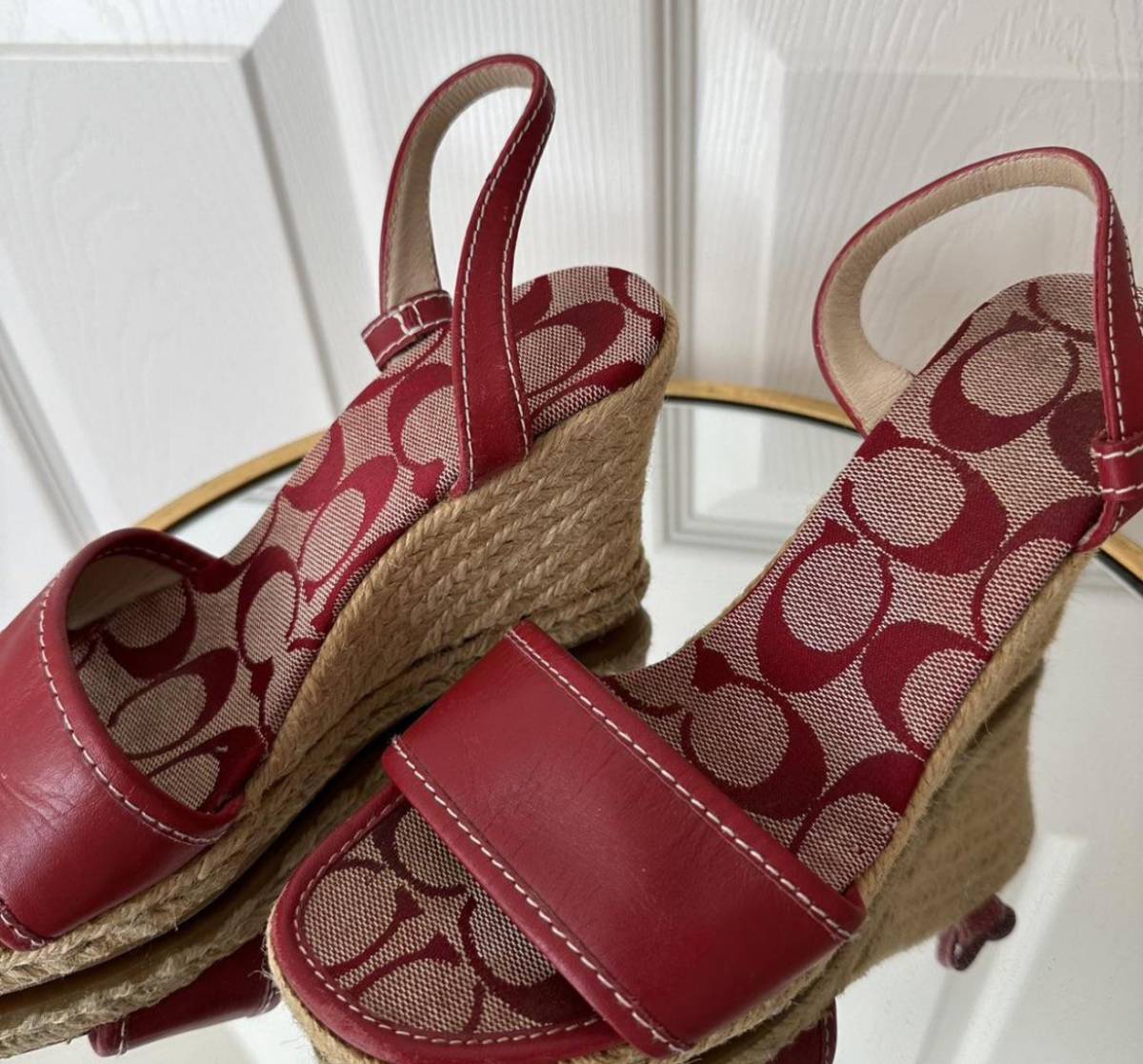 Red Coach logo-print fabric and leather wedge sandals with slingback straps and jute-wrapped heels.