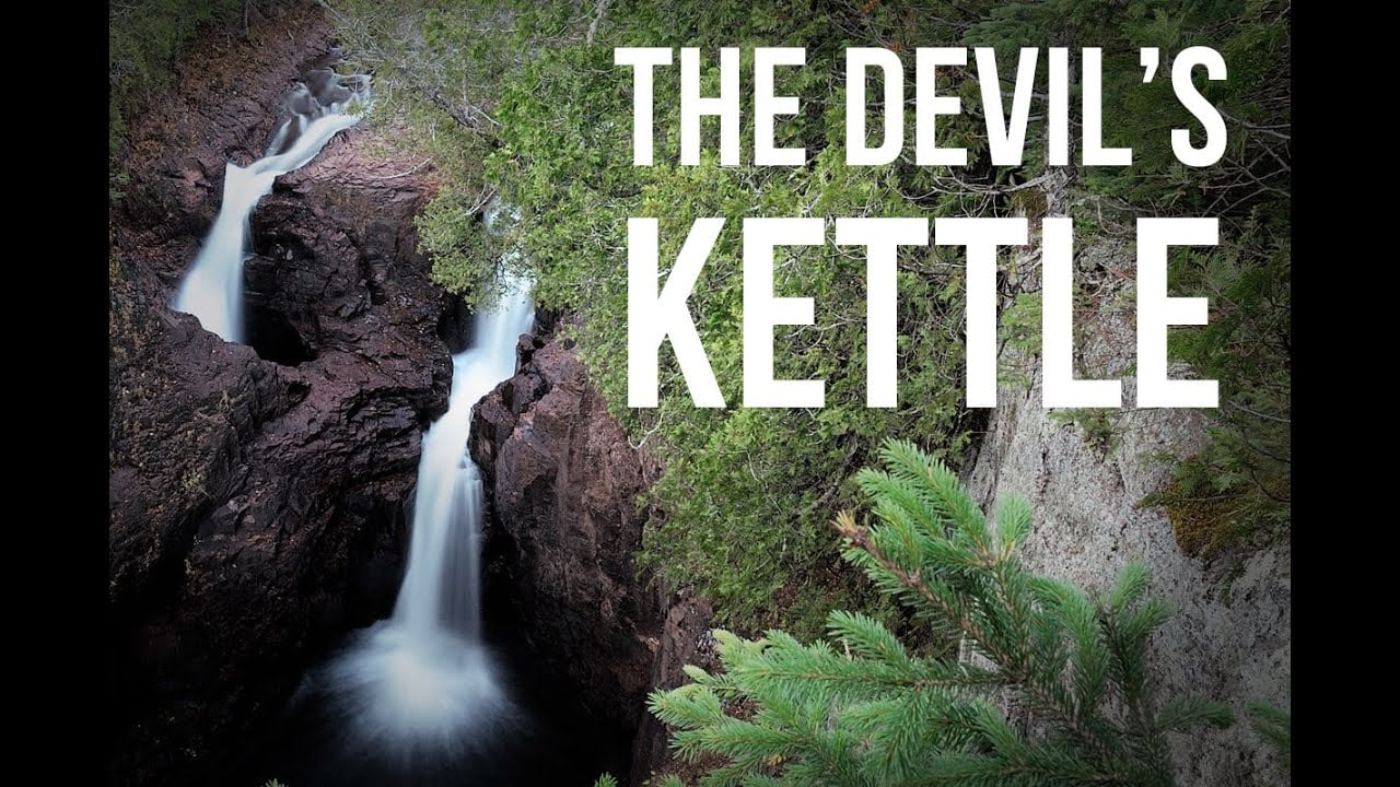 The Devil’s Kettle waterfall cascading into a rocky pool, with the words “THE DEVIL’S KETTLE” overlaid in white text.