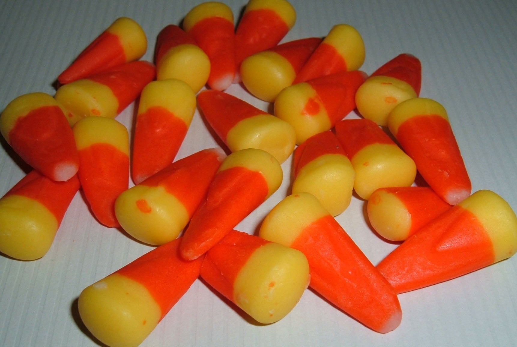 A pile of scattered candy corn pieces.