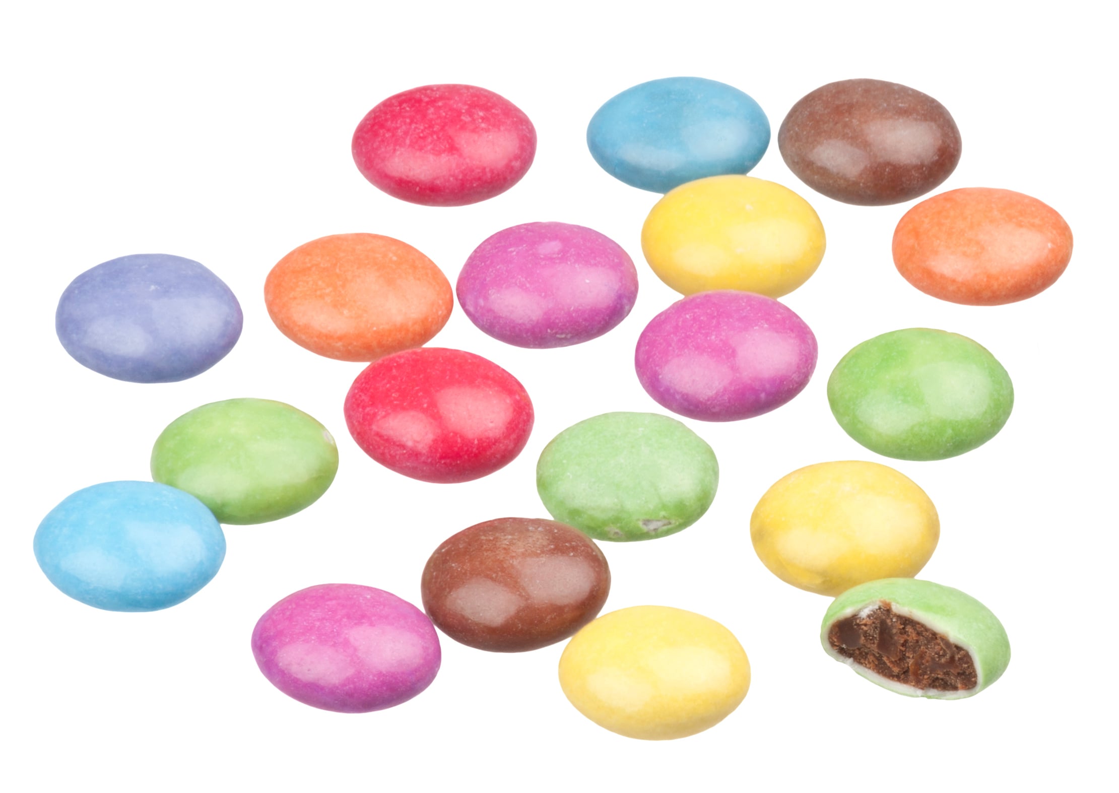 A scattered collection of colorful, round, chocolate-coated candies, with one piece bitten to show a dark chocolate center.