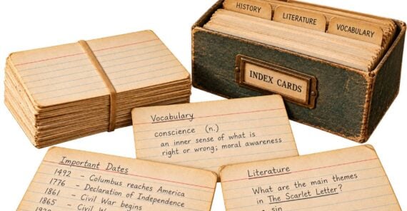 A wooden index card box labeled “Index Cards” sits next to a stack of cards and three sample cards featuring notes on vocabulary, important historical dates, and literature themes.