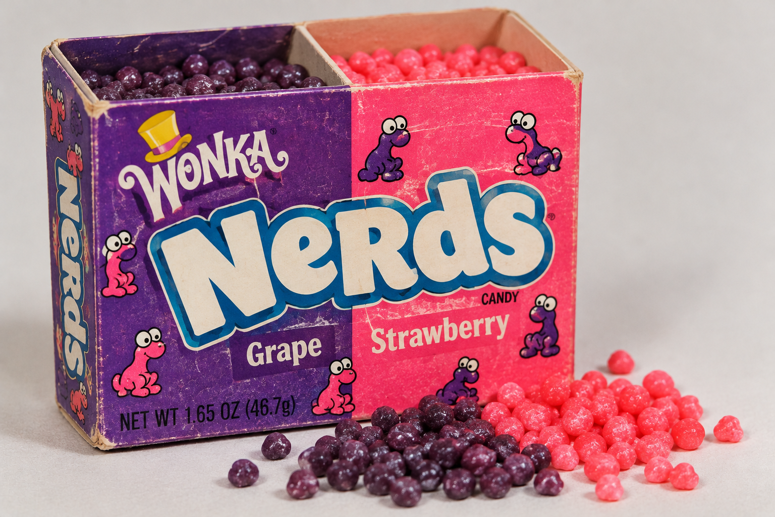 A dual-compartment box of Wonka Nerds candy with grape and strawberry flavors, shown with loose candies scattered in front.