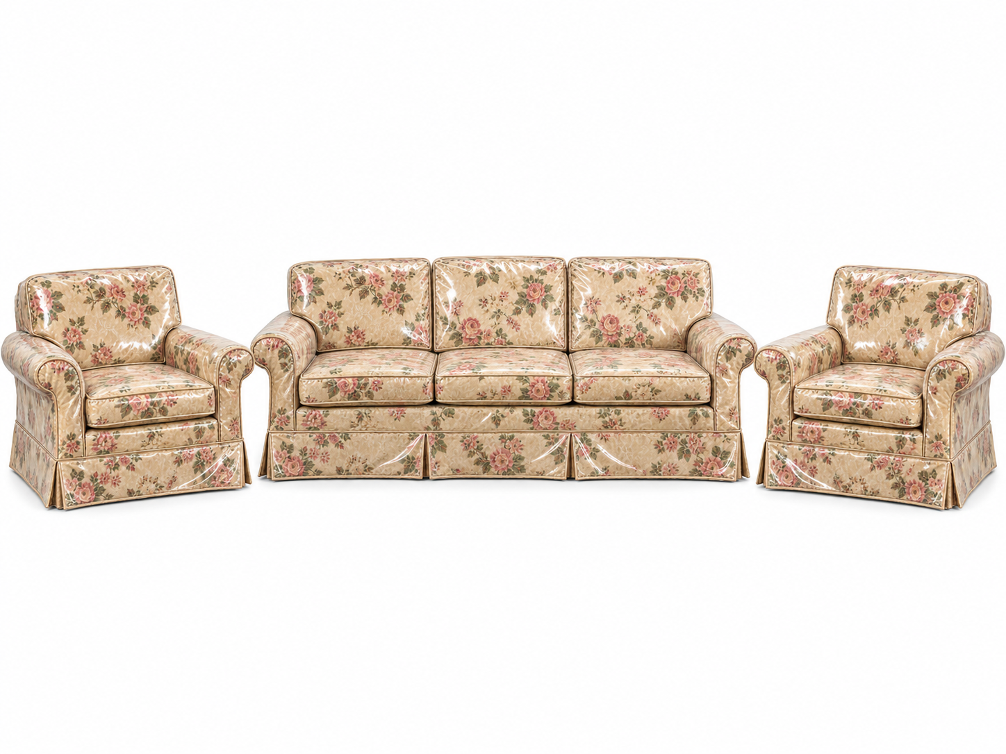 A three-piece living room set consisting of a sofa and two armchairs, all upholstered in a floral fabric and covered in clear plastic protectors.