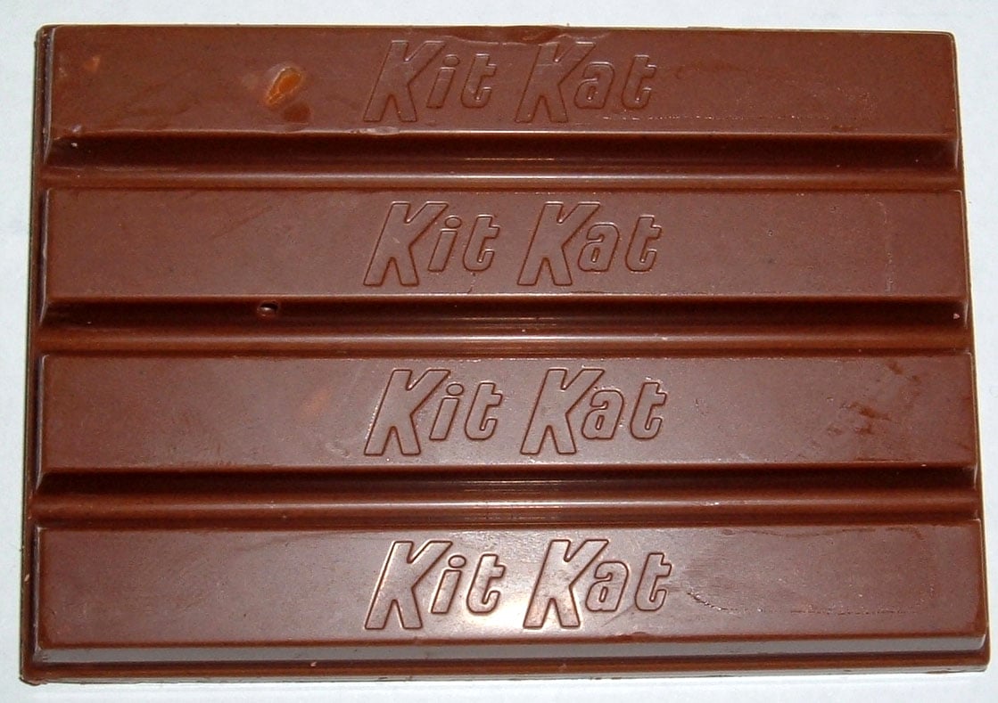 A four-finger milk chocolate Kit Kat bar with the brand name embossed on each section.