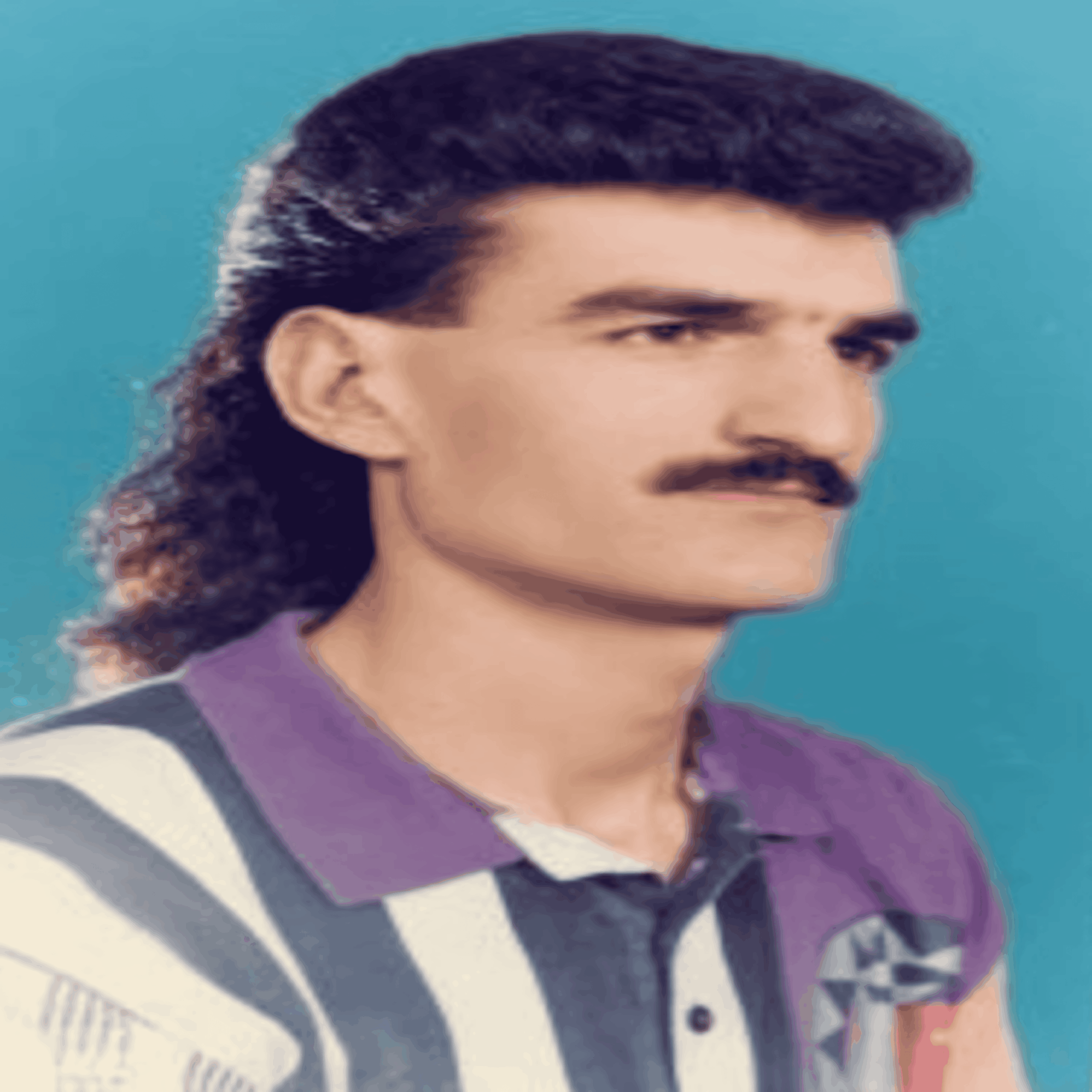 Portrait of a man with a mustache and a mullet hairstyle wearing a striped polo shirt.