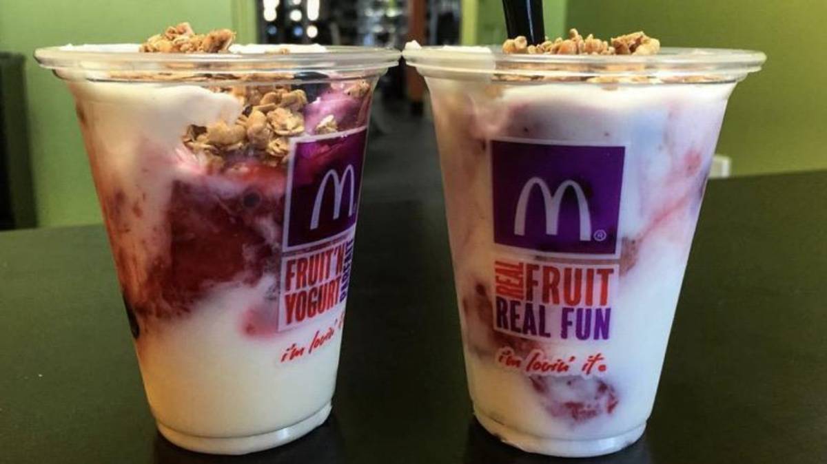 Two plastic cups of McDonald’s fruit and yogurt parfaits topped with granola.