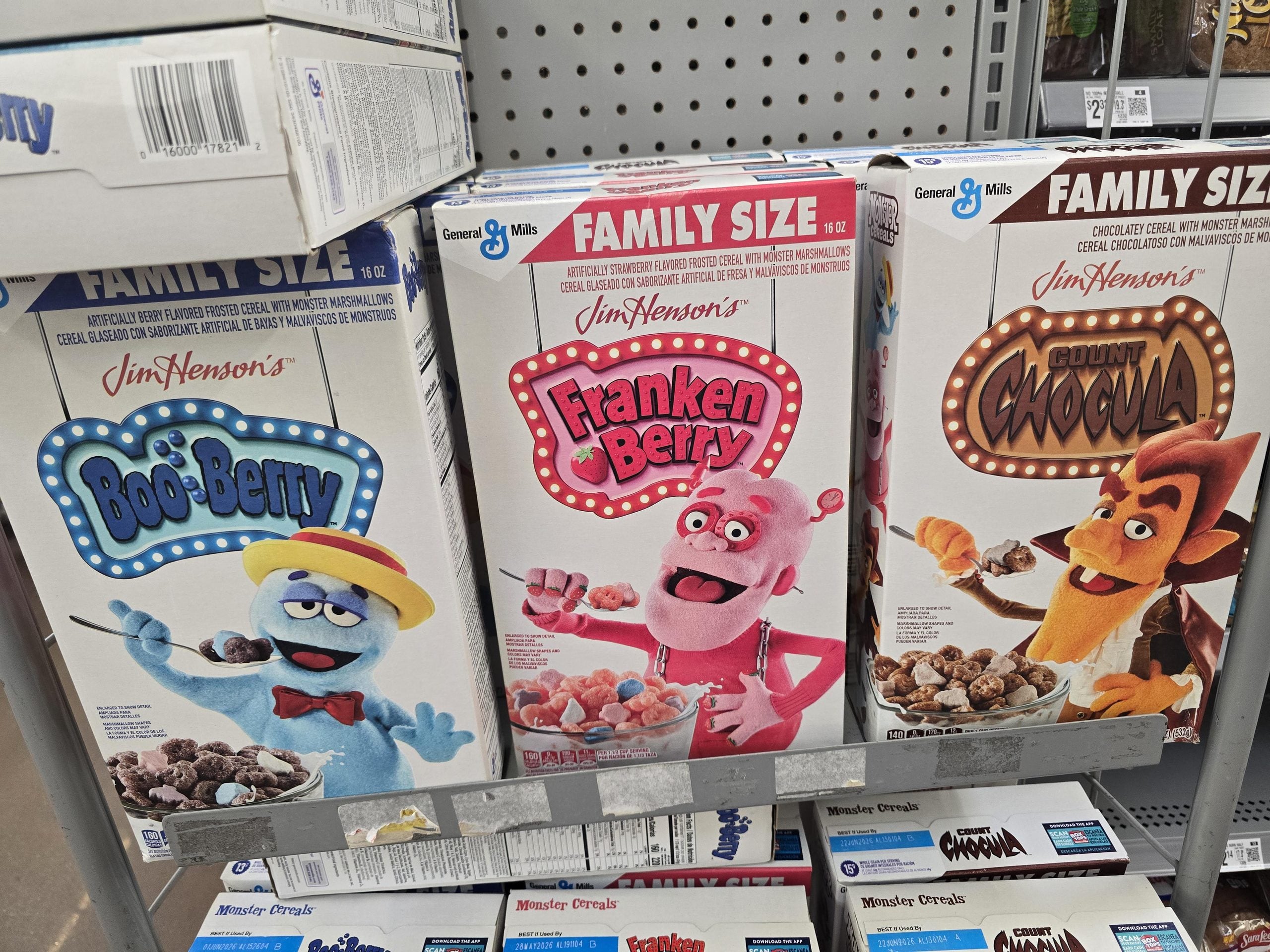 Three boxes of Monster Cereal on a store shelf: Boo-Berry, Franken Berry, and Count Chocula.