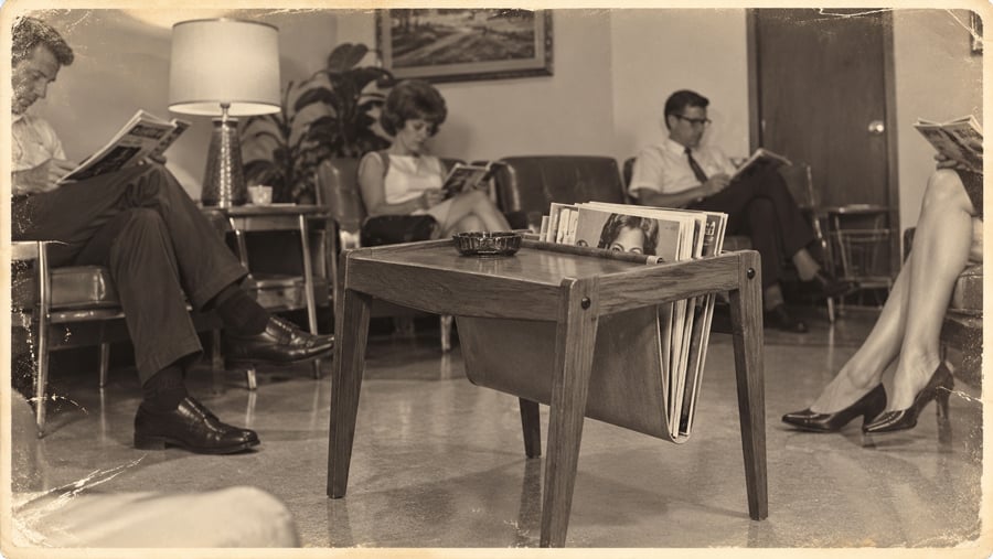 People sitting in a mid-century waiting room reading magazines, with a magazine rack on a side table in the foreground.