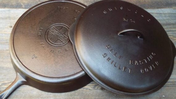 Griswold cast iron skillet and matching self-basting cover with logo and embossed text.