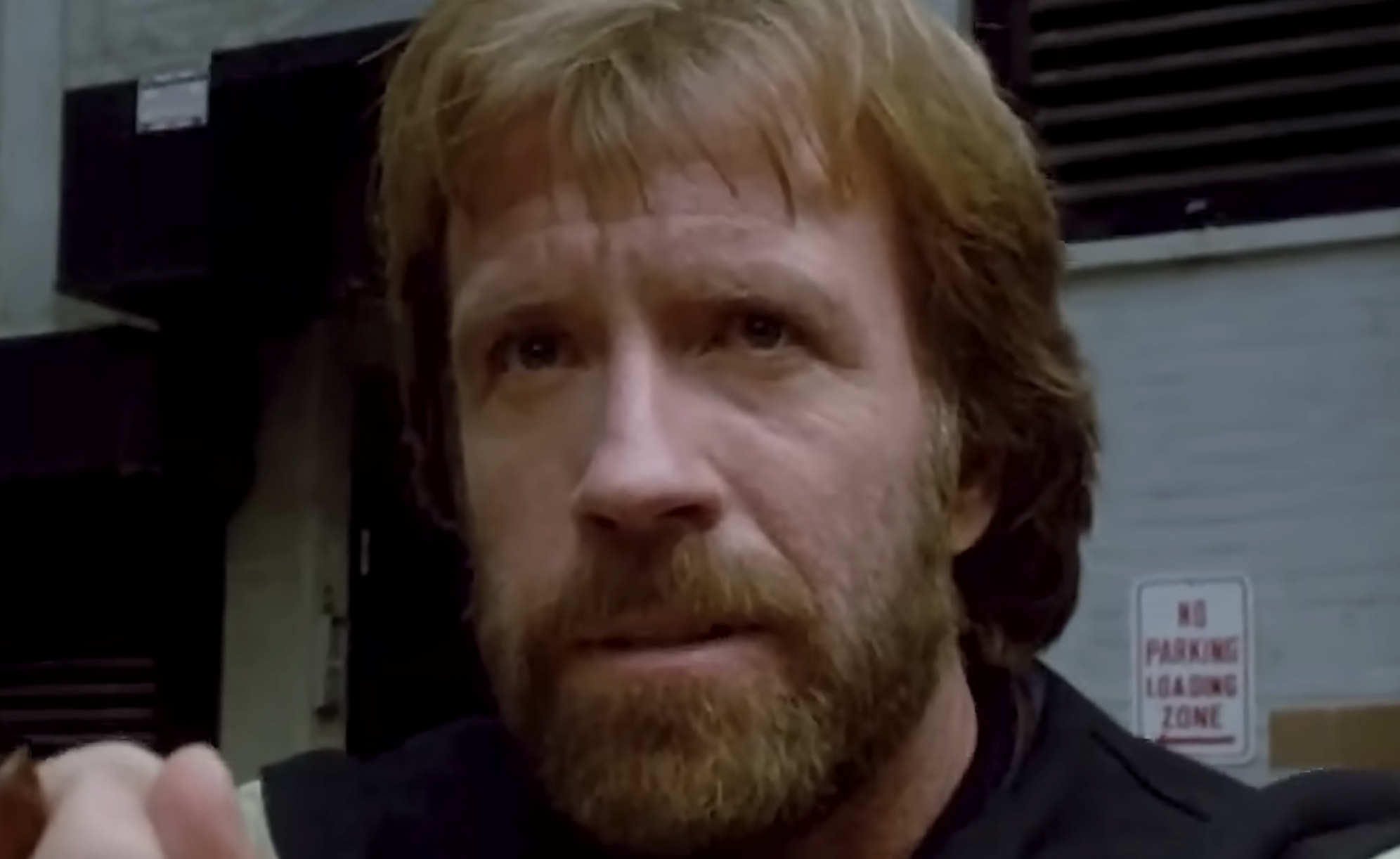 Chuck Norris with a beard looking directly at the camera.