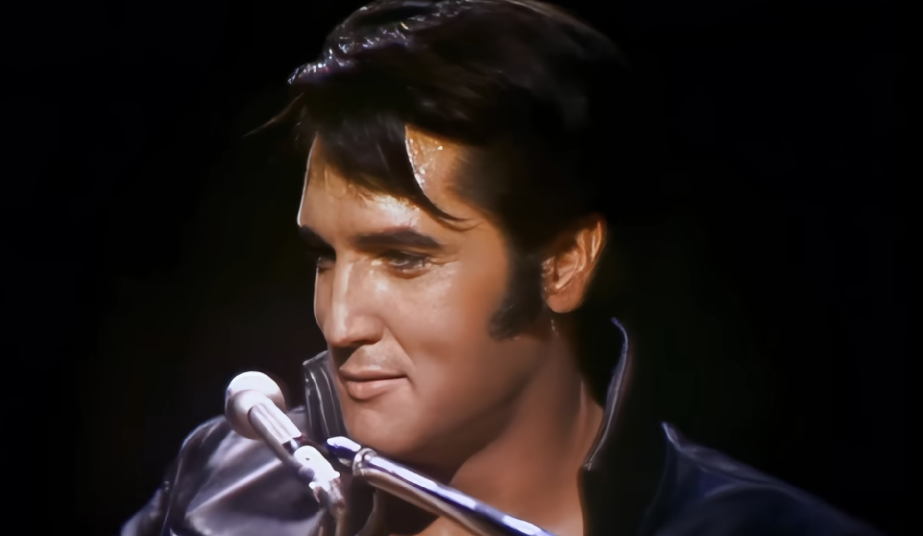 Elvis Presley singing into a microphone.