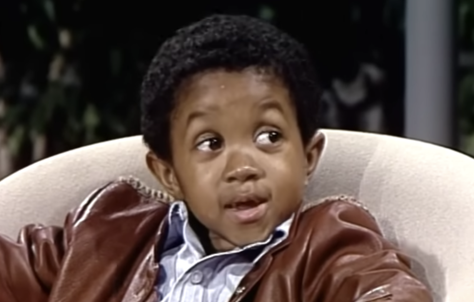 Gary Coleman sitting in a chair and looking to the side.