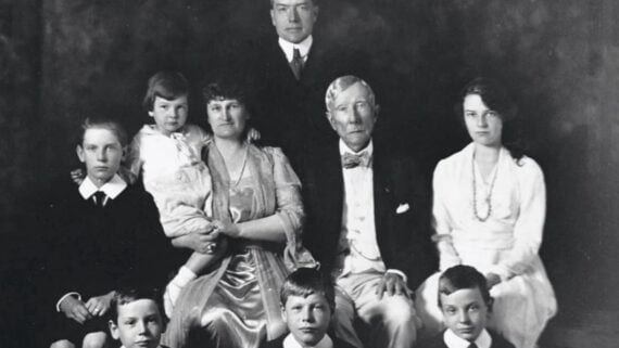 A formal black-and-white studio portrait of a multi-generational family.