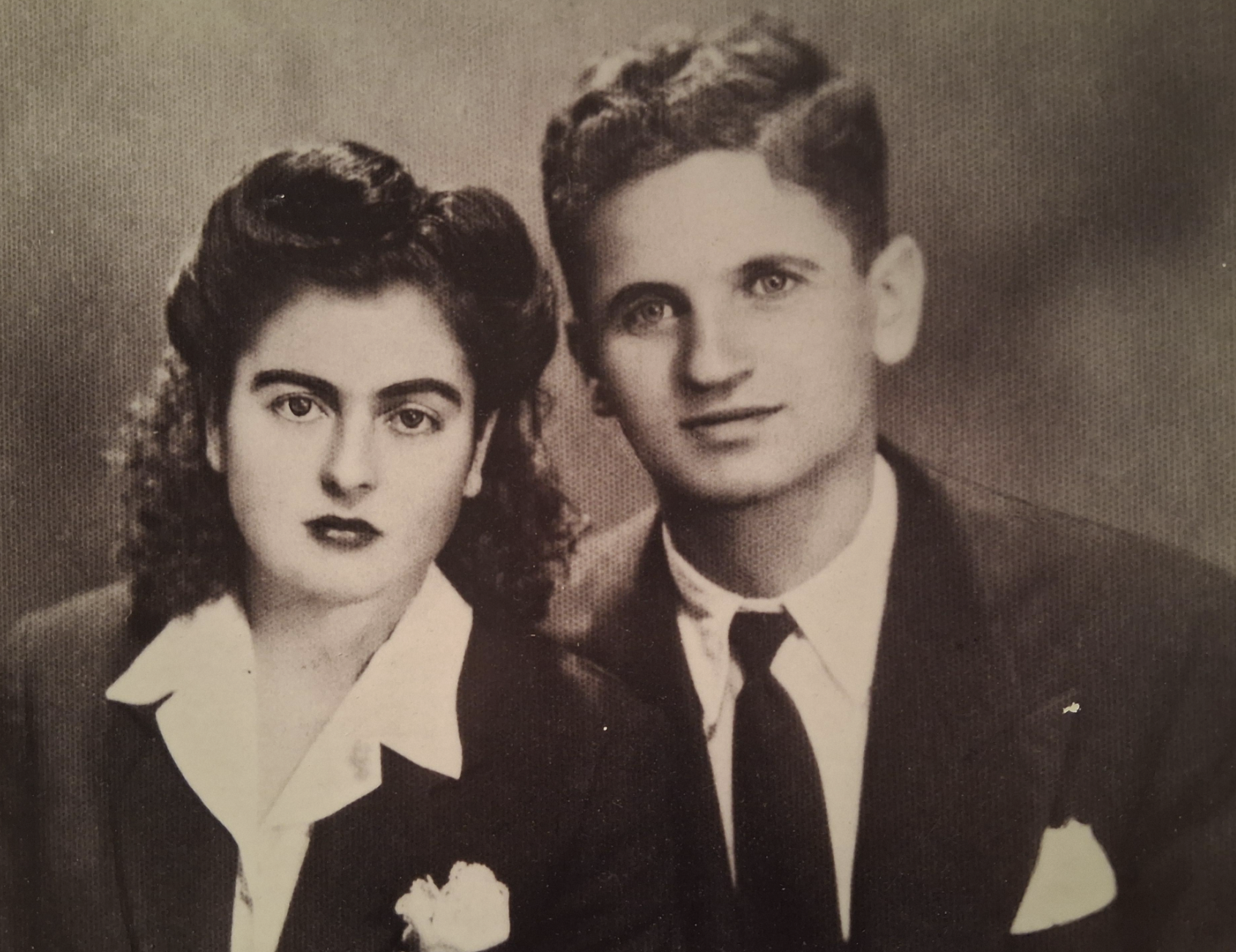 A vintage portrait of a young man and woman dressed in formal attire.