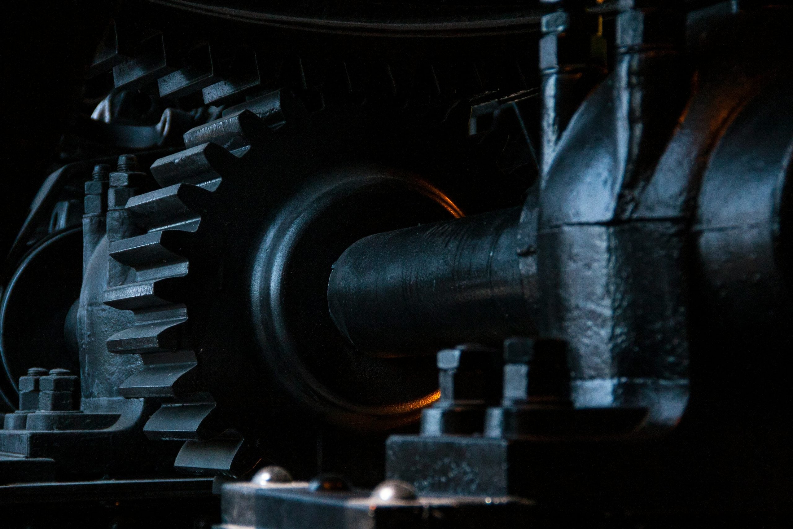 Close-up of a large metal gear assembly with a central axle.