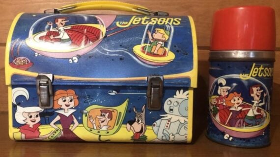 A vintage The Jetsons metal lunchbox with a matching thermos featuring the cartoon characters in flying vehicles.