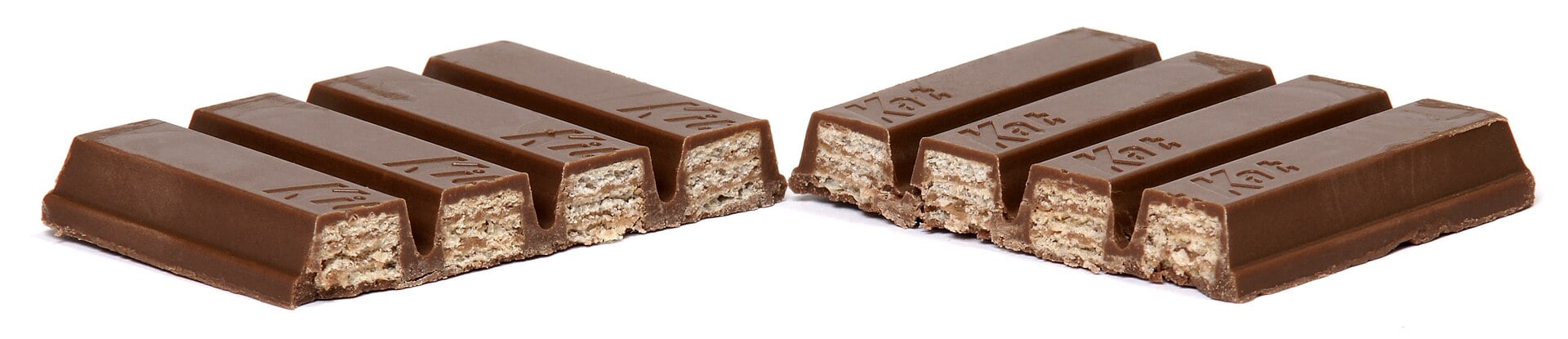 Two KitKat chocolate wafer bars broken into individual fingers, revealing the layered wafer interior.