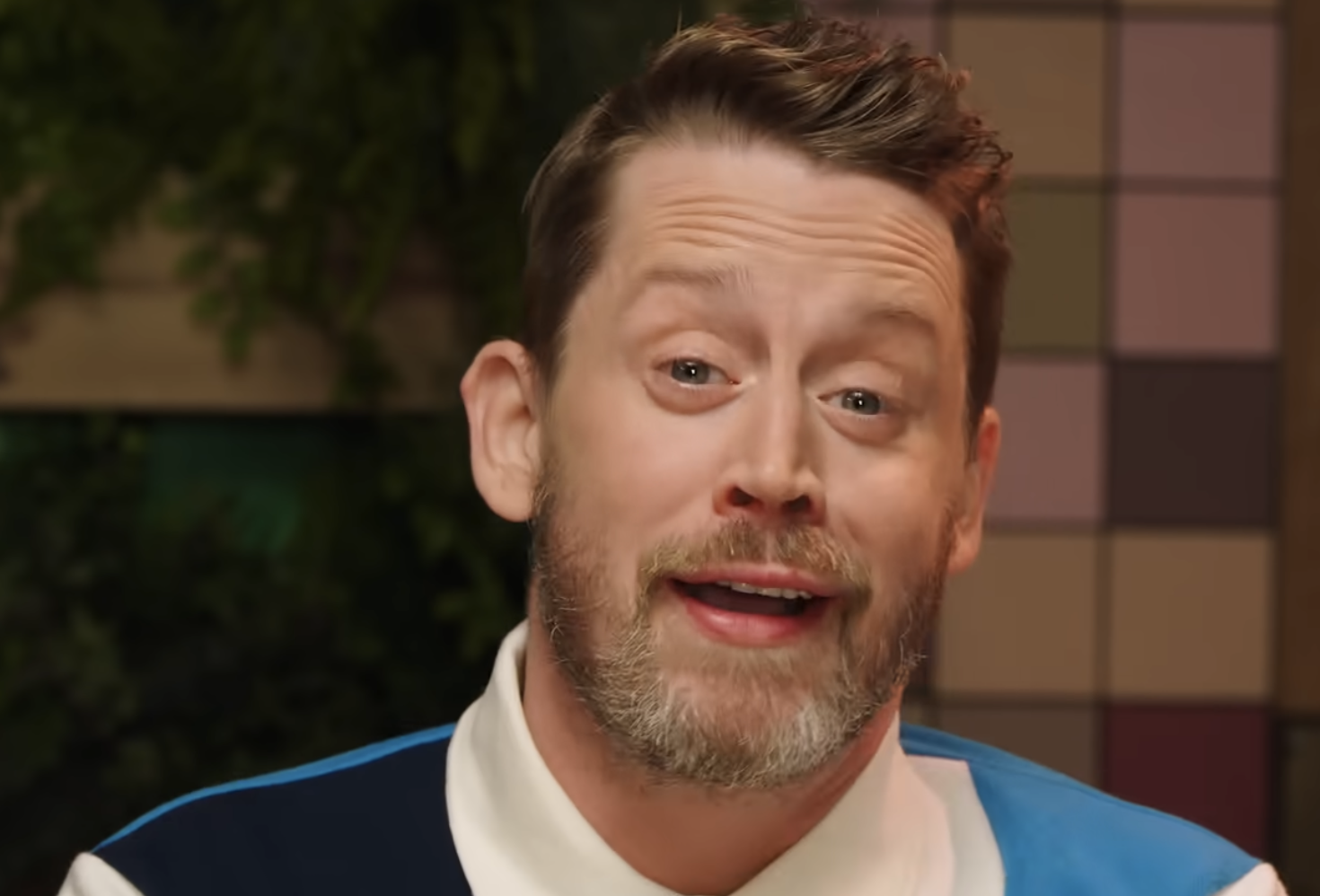 A portrait of actor Macaulay Culkin looking at the camera.